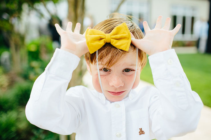 kid with a bowtie at a wedding