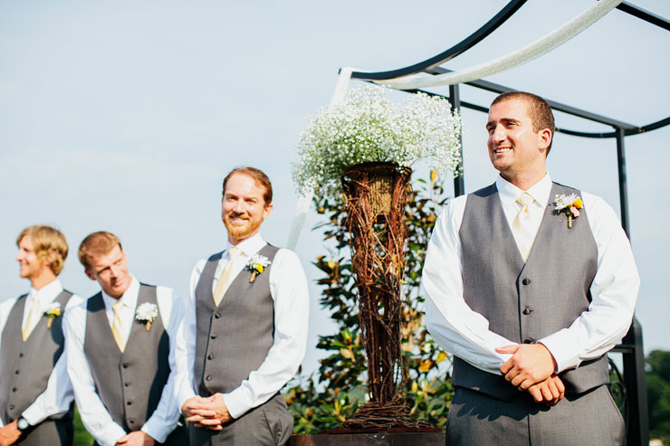 groom watching bride walk down aisle