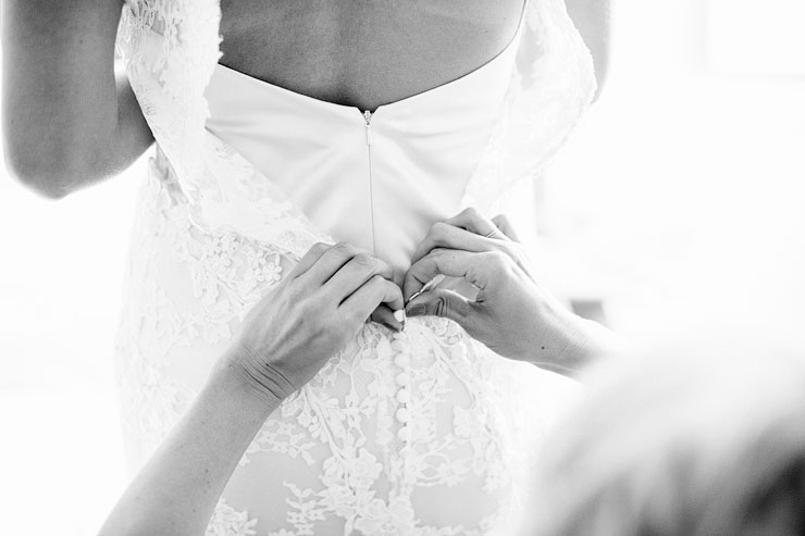 buttoning the wedding dress