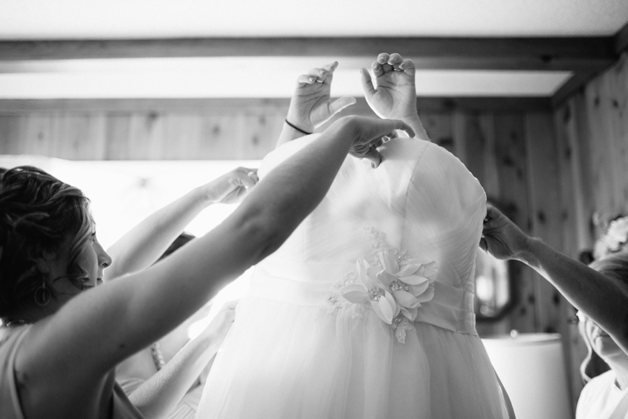 bride putting on dress