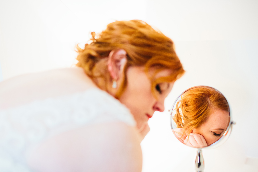 bride putting earrings in