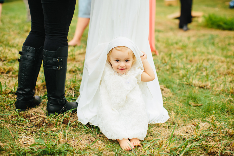 kid poking out of wedding dress